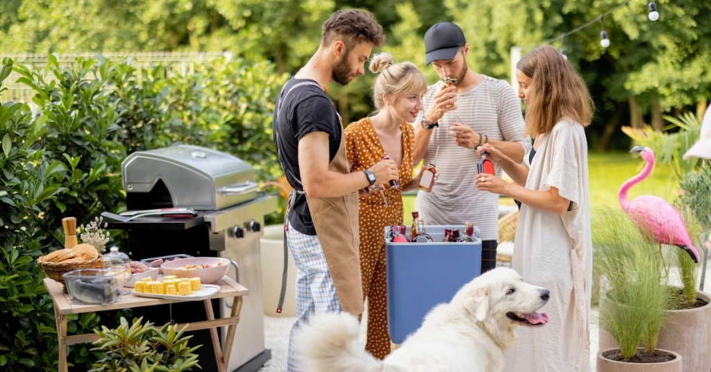 Backyard barbecue in Oklahoma City with friends, drinks, and a happy dog, showing a pet-friendly and guest-ready yard.