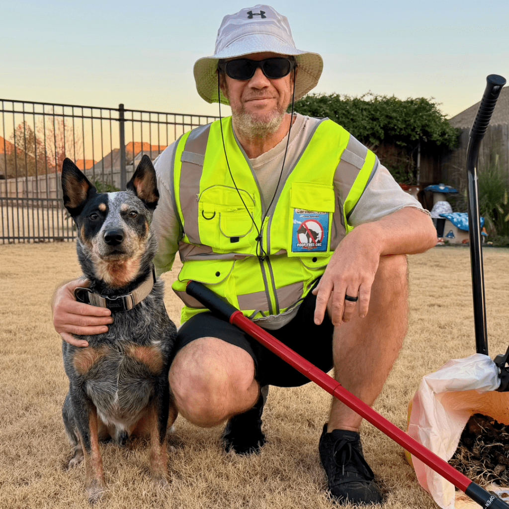 Carlton, owner of Poop Free OKC, kneeling beside a dog during professional pet waste removal service in Oklahoma City.