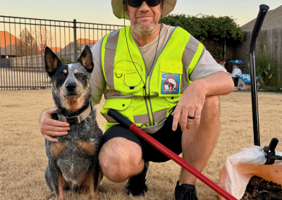 Poop Free OKC technician with dog after yard cleanup.