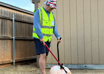 Poop Free OKC owner performing dog poop cleanup in backyard.