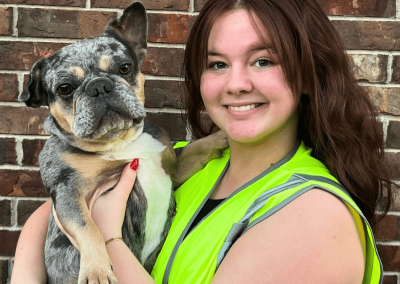 Poop Free OKC technician holding a happy client’s dog in Edmond, Oklahoma.