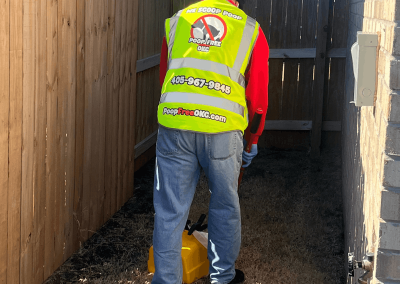 Poop Free OKC owner Carlton Wolf performing professional pet waste removal in a residential backyard in El Reno, Oklahoma.