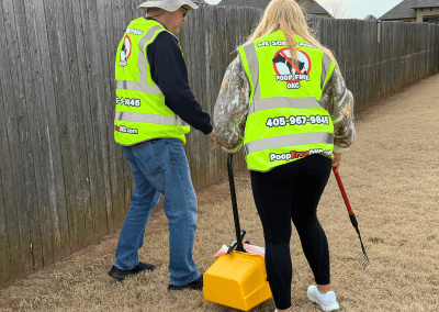 Poop Free OKC training scoop technicians during professional pet waste removal service at a residential property in Oklahoma City.