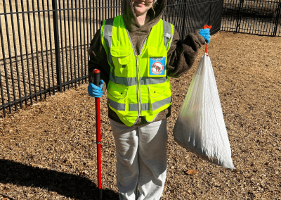 Poop Free OKC scoop technician holding collected pet waste during professional dog poop removal service in Oklahoma City.