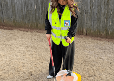 Poop Free OKC scoop technician providing professional pet waste removal in a residential backyard in Yukon, Oklahoma.