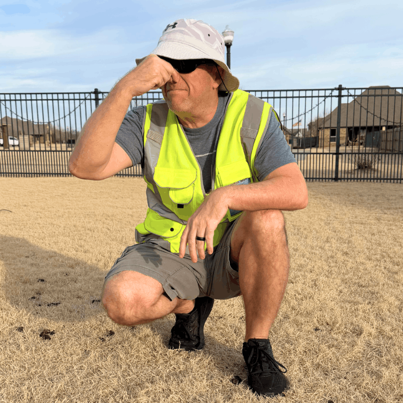 Technician about to treat a backyard lawn with pet-safe deodorizer to keep dog odors under control year round.
