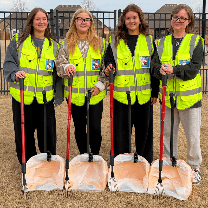 Professional Poop Free OKC team providing OKC pooper scooper services with pet waste removal tools in an Oklahoma City backyard.